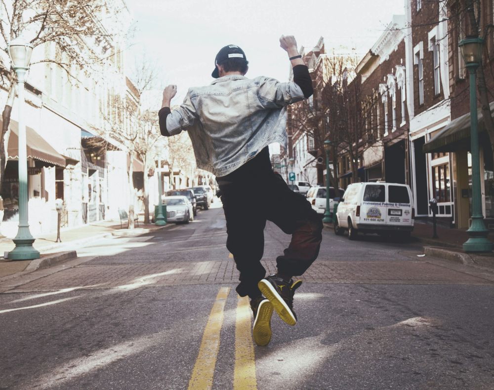 Jeune homme qui saute dans les airs et fait cogner ses talons ensemble